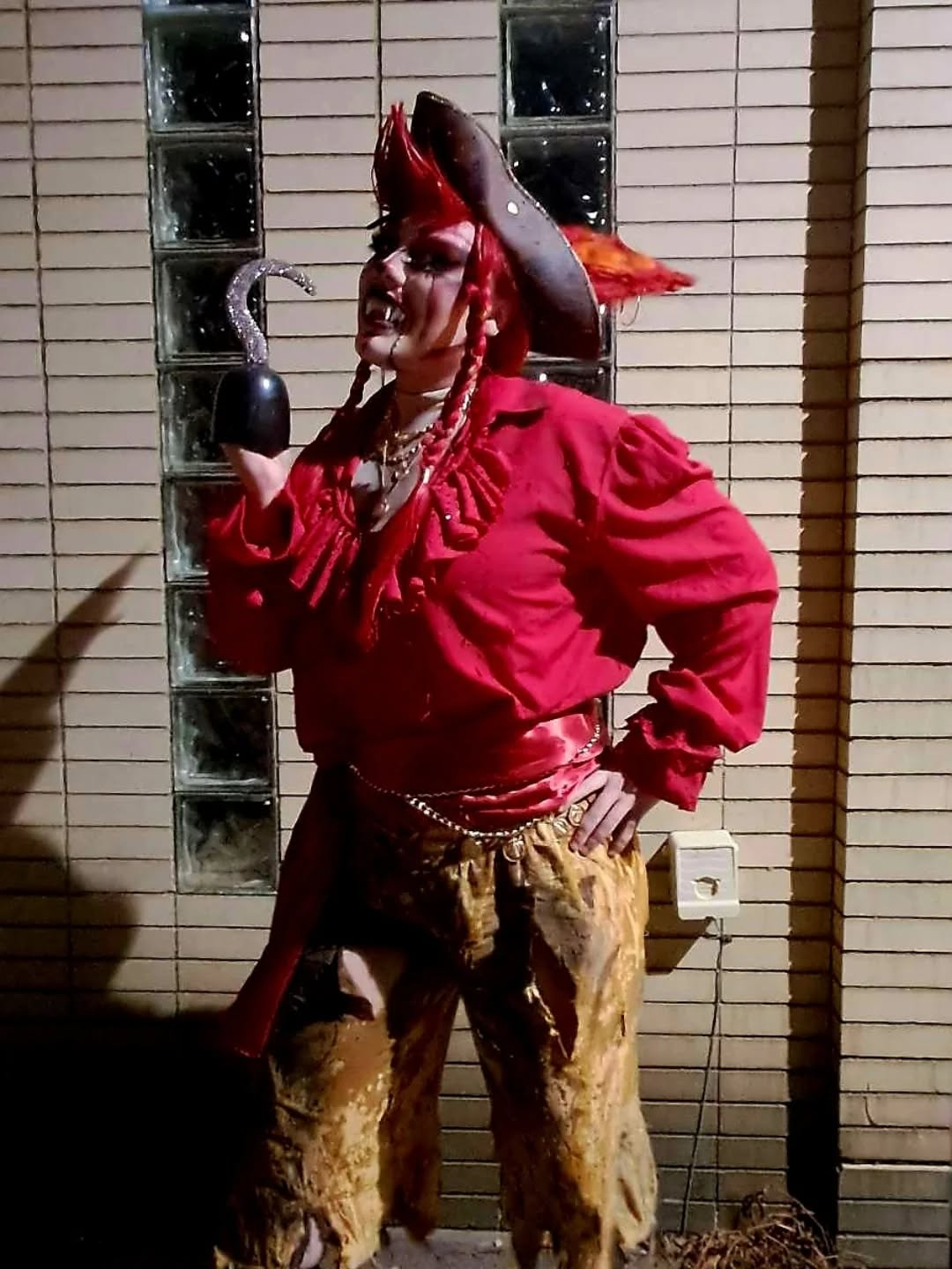 Dyke Tyson performing as Captain Bloodfang in a theatrical red costume.