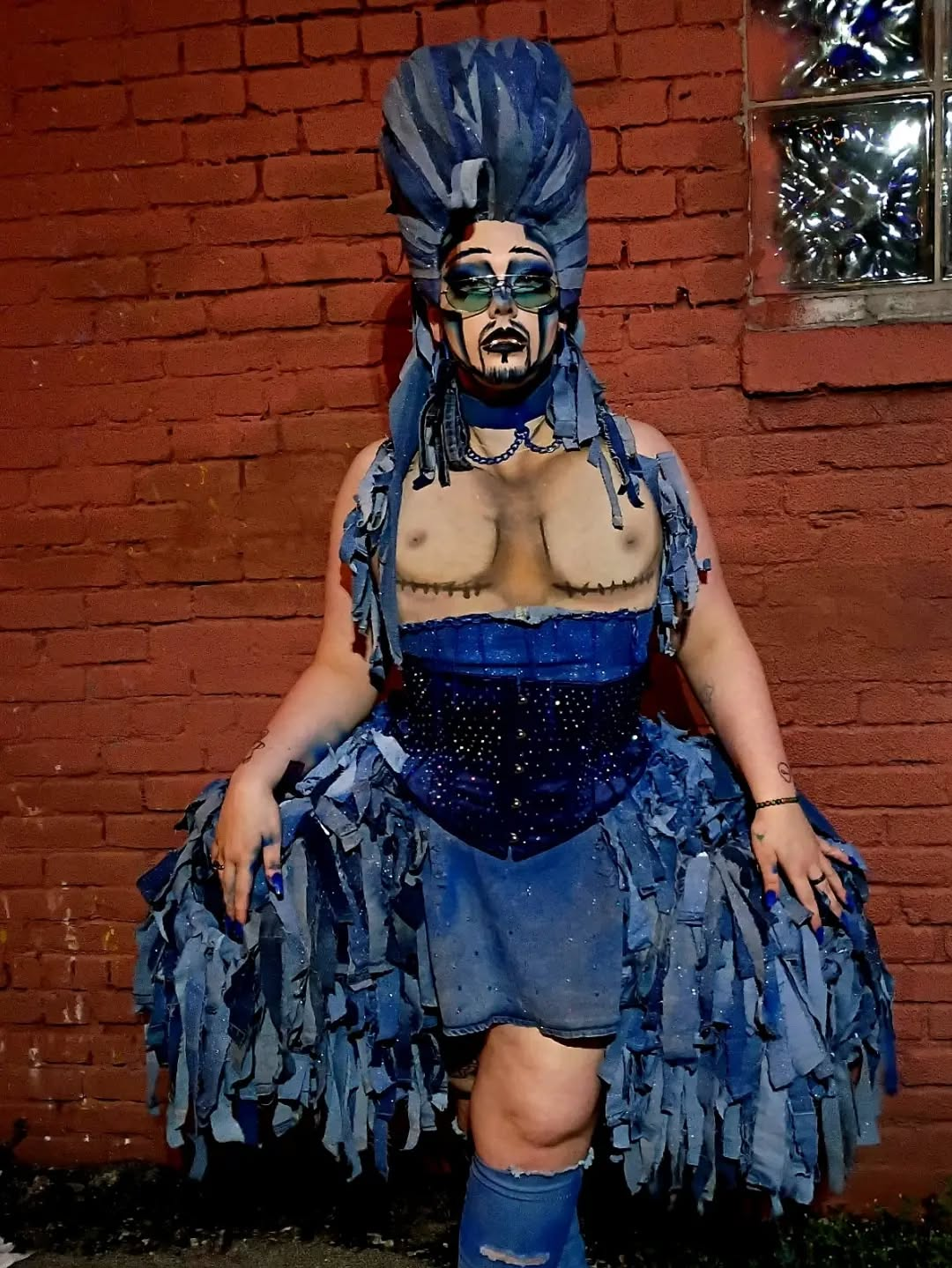 Dyke Tyson in a blue denim-inspired drag character look.