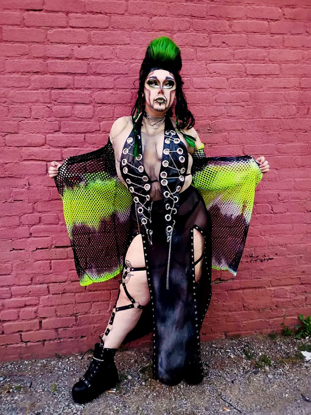 Dyke Tyson in a black and neon green radioactive drag look.
