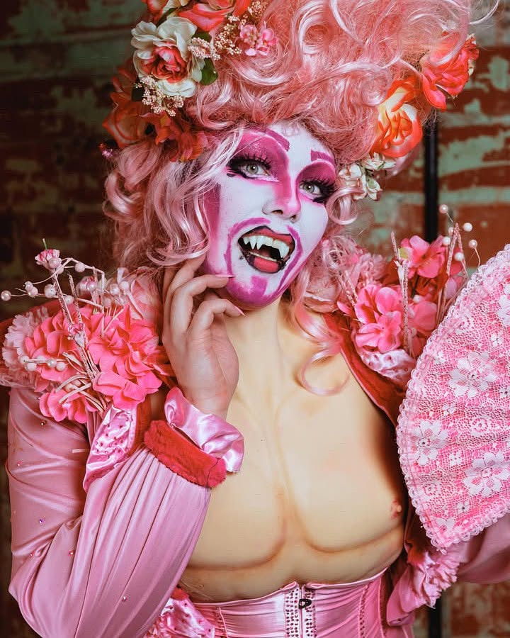 Dyke Tyson in a dramatic pink floral drag character look.